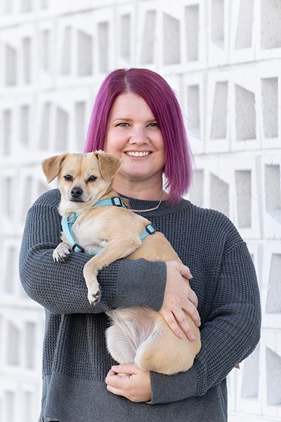 Sherrie & Sunny A woman holding a small dog.