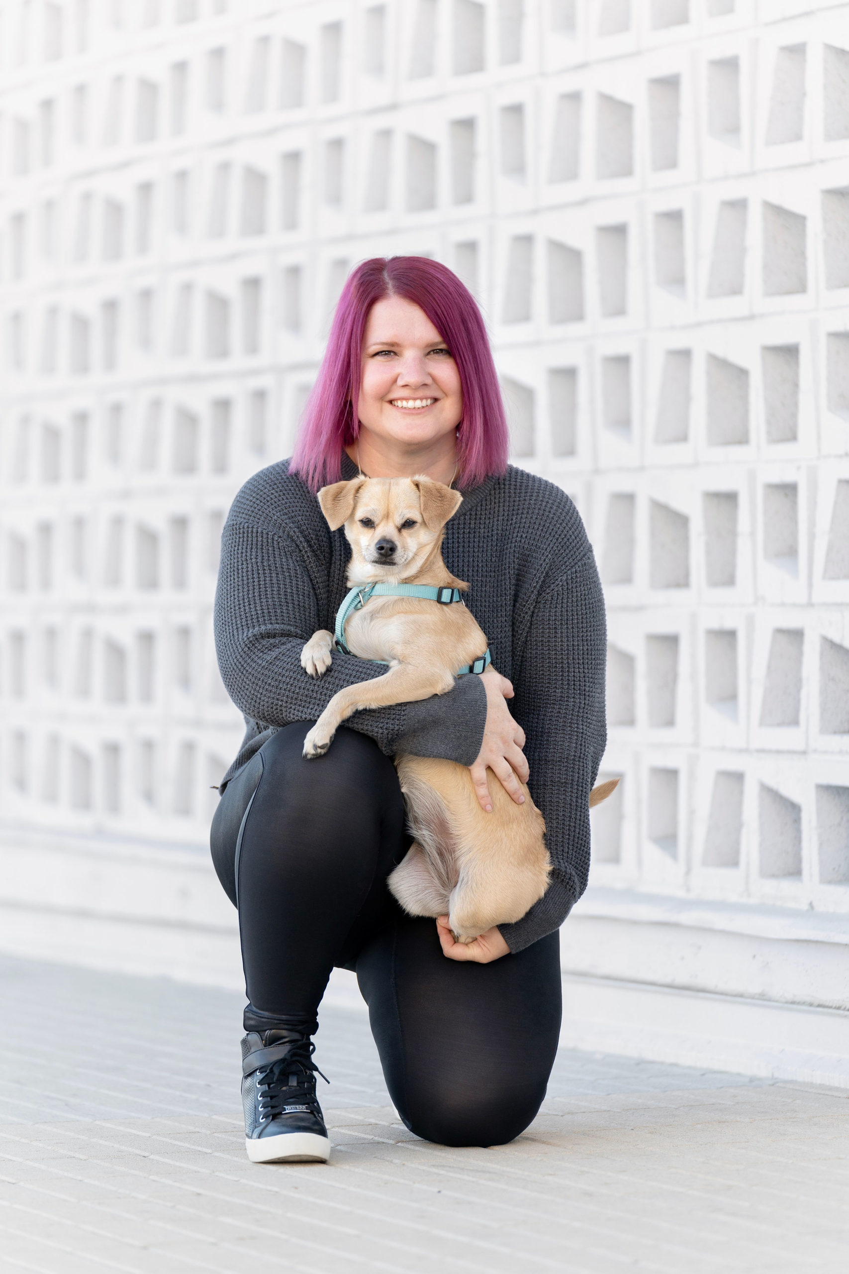 Sherrie & Sunny A woman holding a small dog.